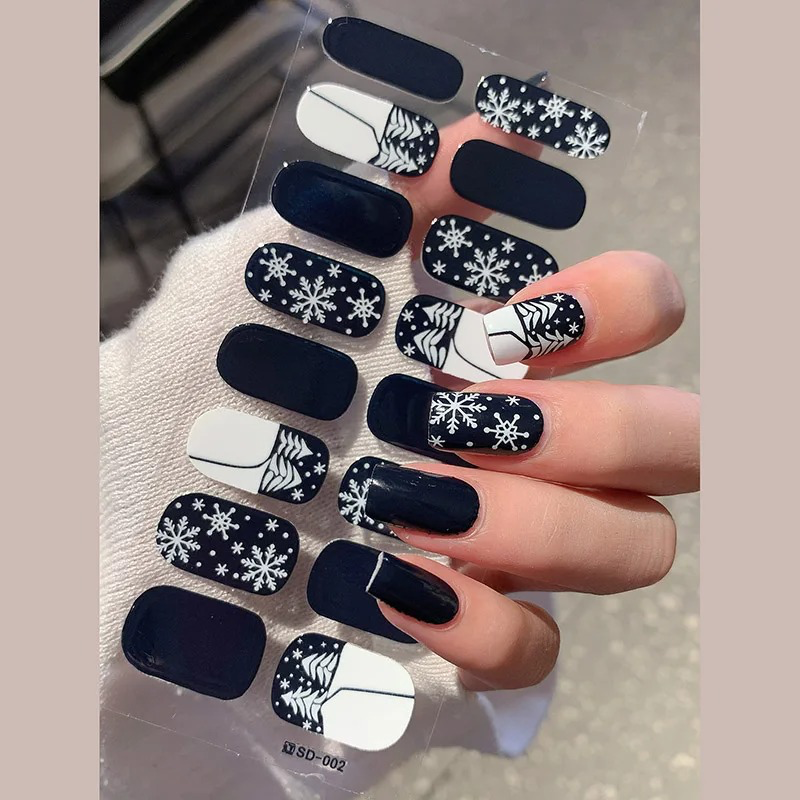 Winter-inspired nail wraps with classic blue and white snowflake patterns.